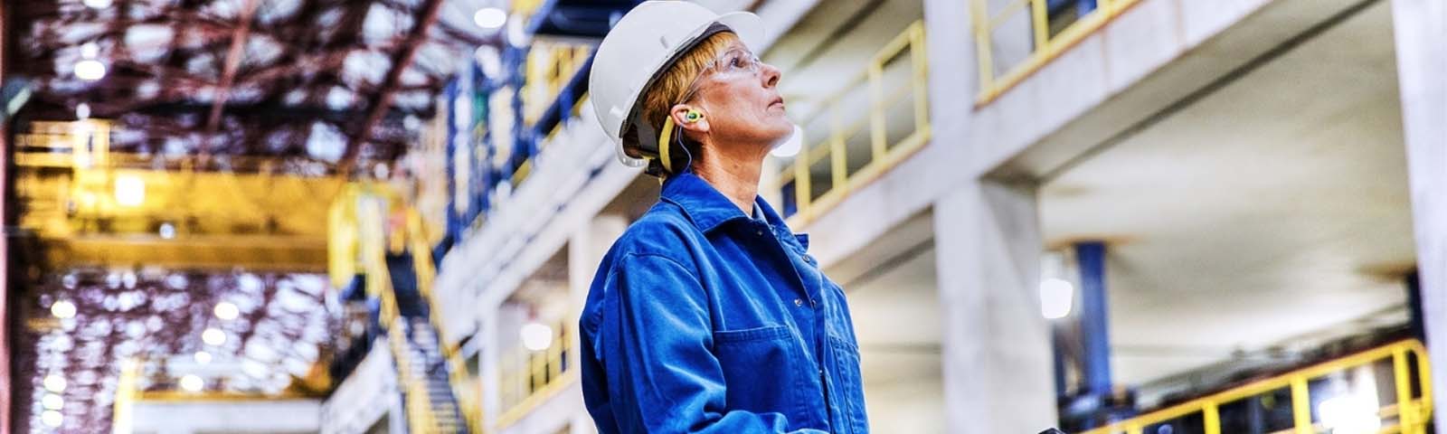 A factory worker looking up at the factory