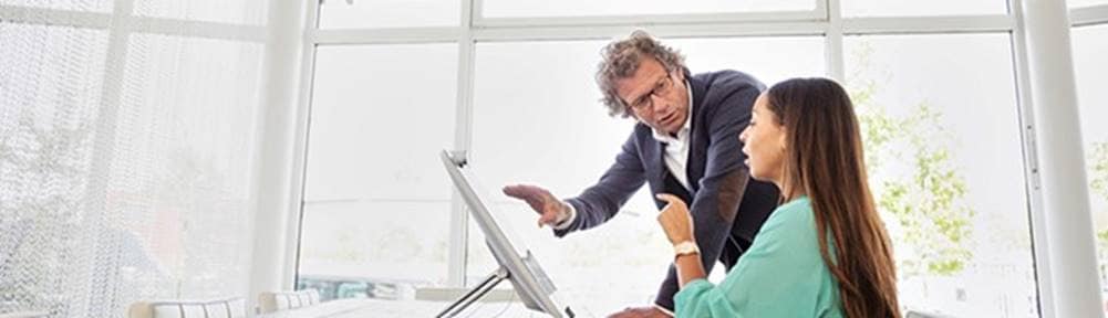 Two people looking at a computer screen