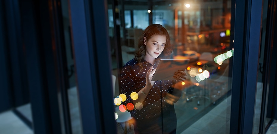 Cropped shot of a young businesswoman working late on a digital tablet in an office