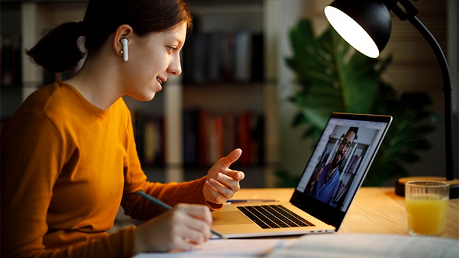 Woman watching a live demo on her laptop